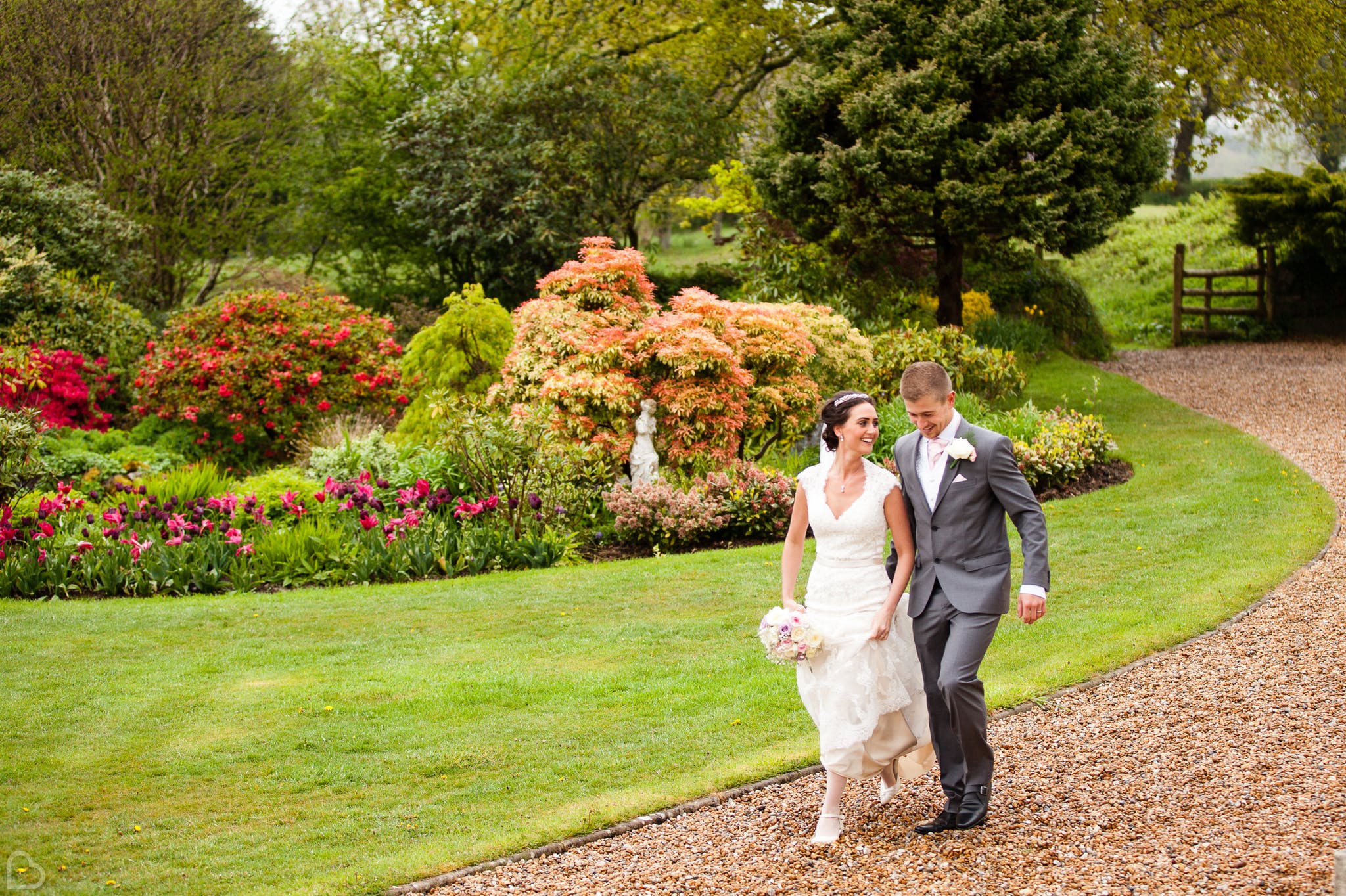 happy newlyweds stroll around moorland garden hotel, a rustic wedding venue in the uk
