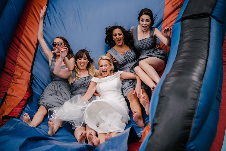 bridebook.co.uk bride and bridesmaids down the slide