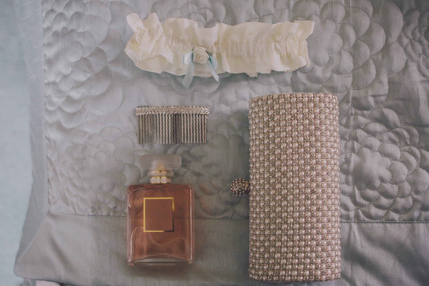 Bridebook.co.uk- bridal purse perfume hair grip and garter laid out
