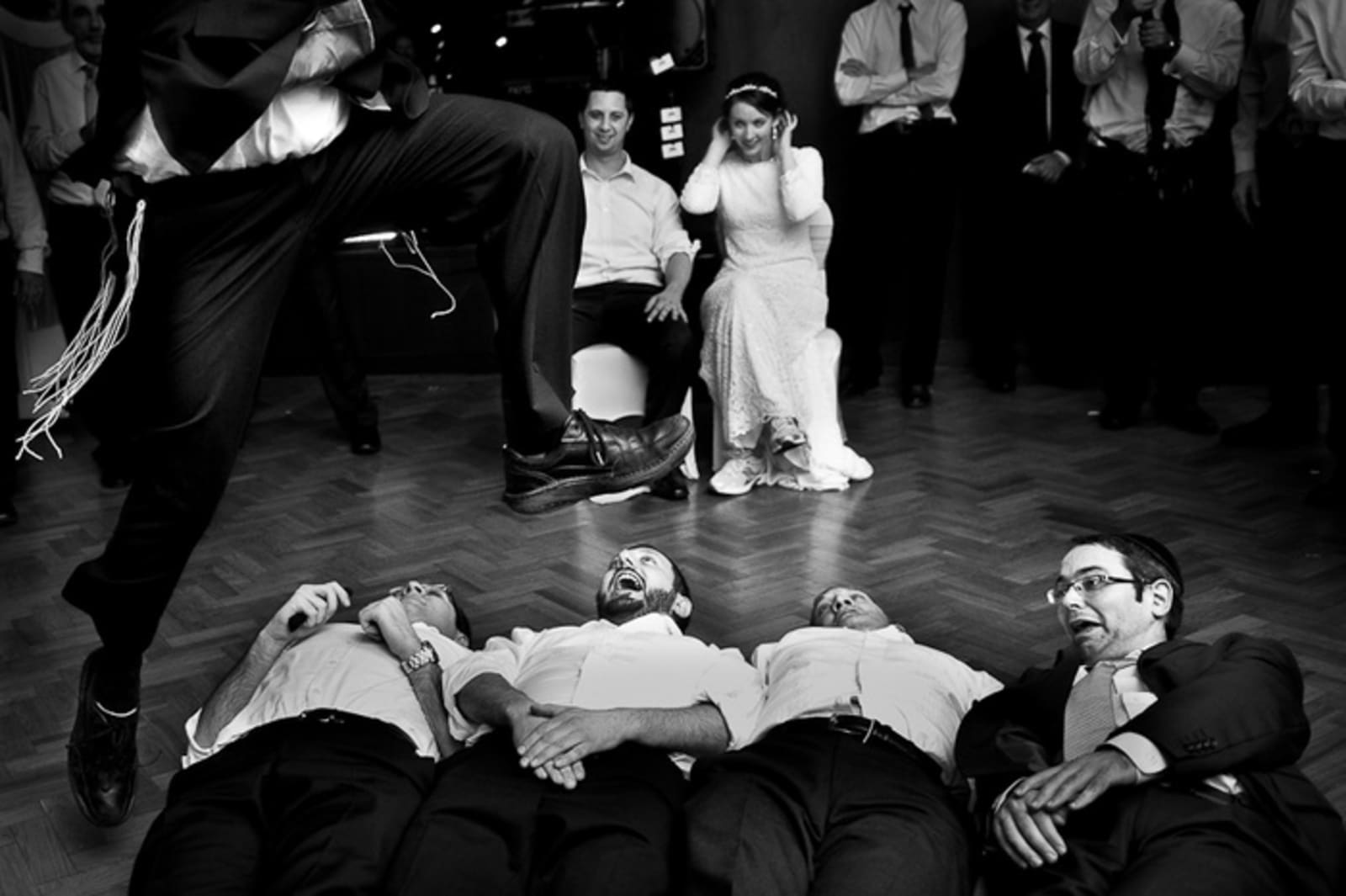 Bridebook.co.uk- bride and groom watching ushers