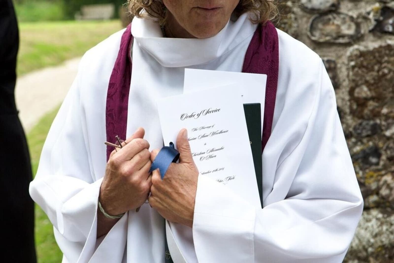 Bridebook.co.uk- vicar standing with order of service