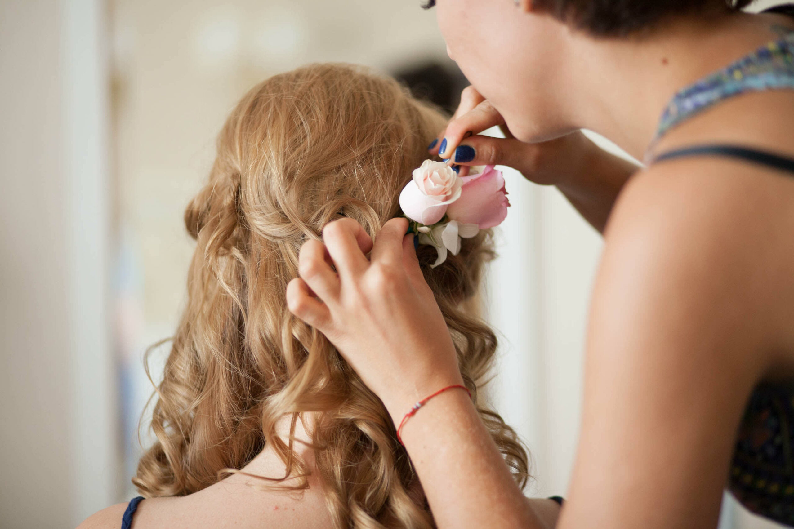 Bridebook.co.uk bride having her hair prepped