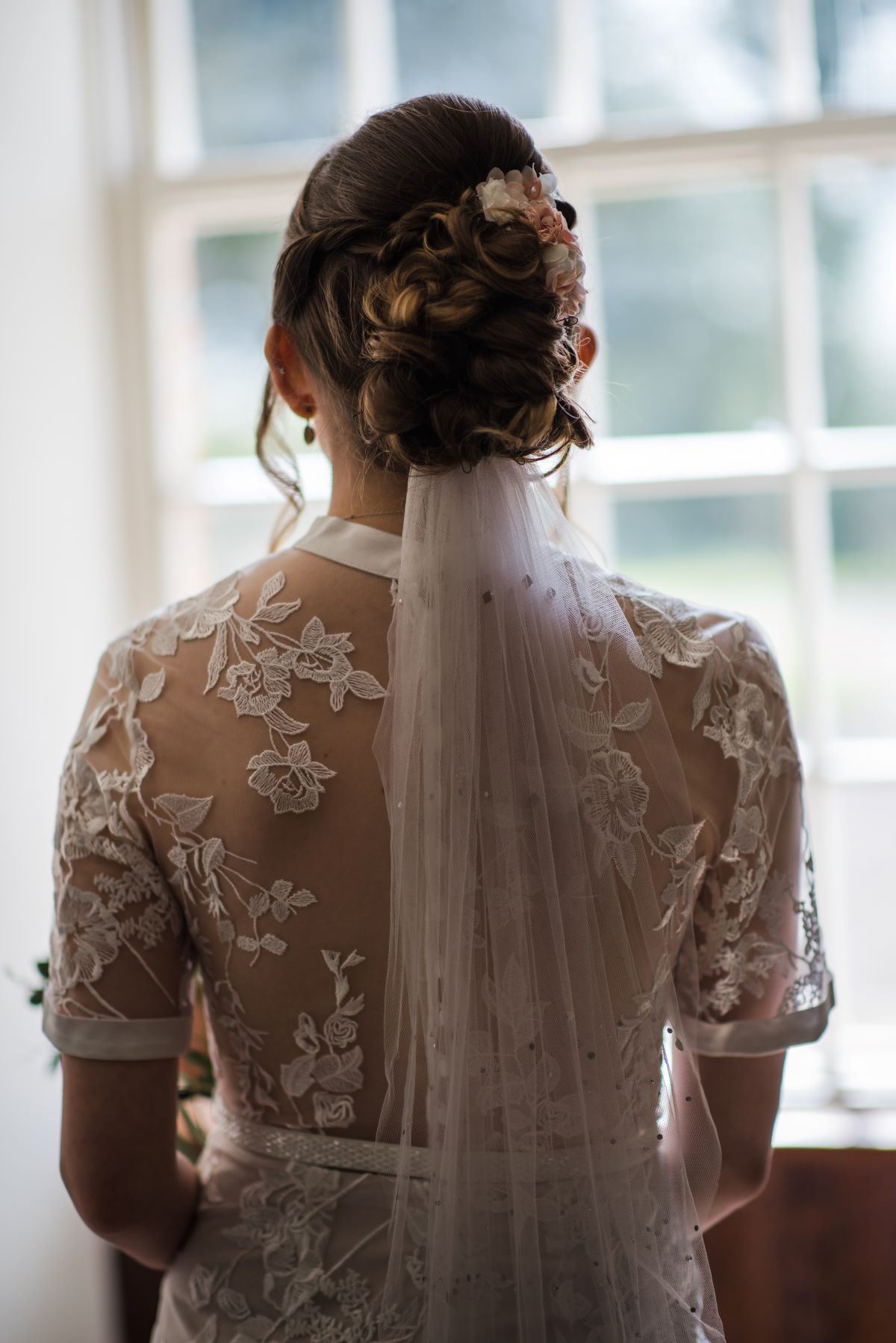 Adam and his best man standing outside the wedding venue in their wedding suits