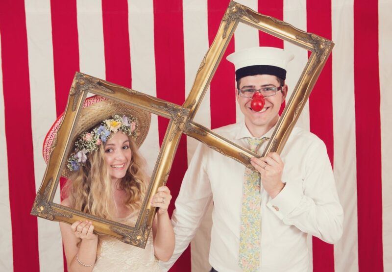 Bridebook.co.uk- bride and groom with props in photobooth