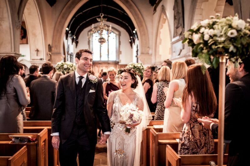 Bridebook.co.uk- bride and groom leaving ceremony after wedding