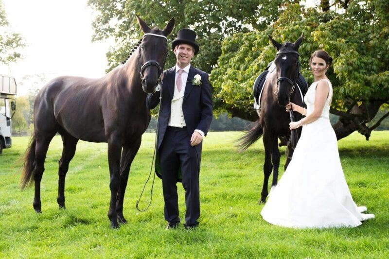 Bridebook.co.uk- bride and groom with two horses