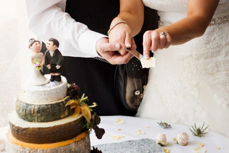 Bridebook.co.uk- bride and groom cutting their cheese cake