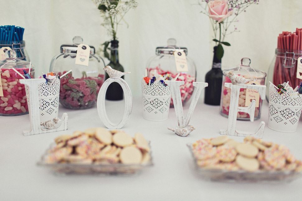 Bridebook.co.uk- love sign in front of desert table