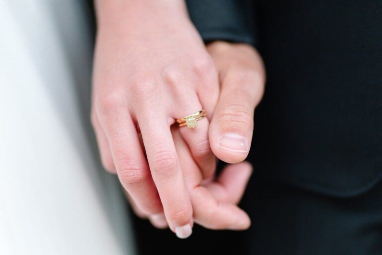 Pair of clasped hands showing off engagement ring