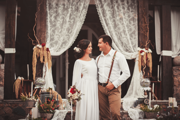 Rustic barn wedding with bride and groom wearing warm outfits