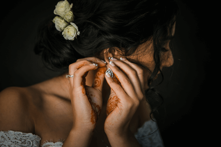 Indian bride getting ready and putting on earrings