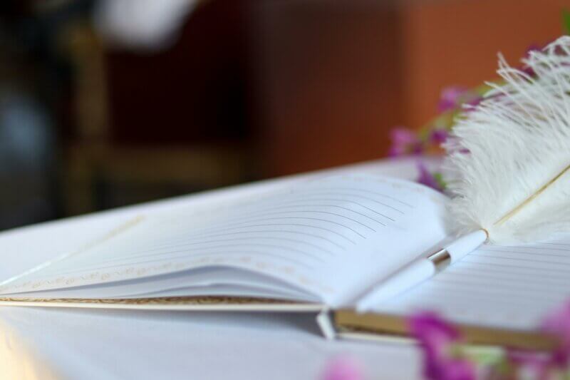 Open book with feather pen