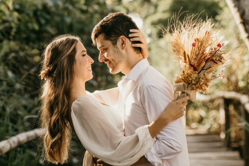 Couple in white with dried flowers bouquet