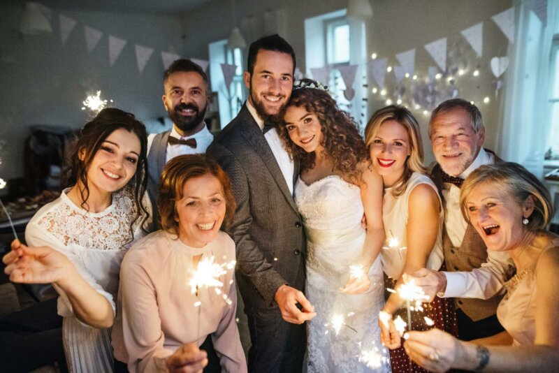 Wedded couple with family and friends