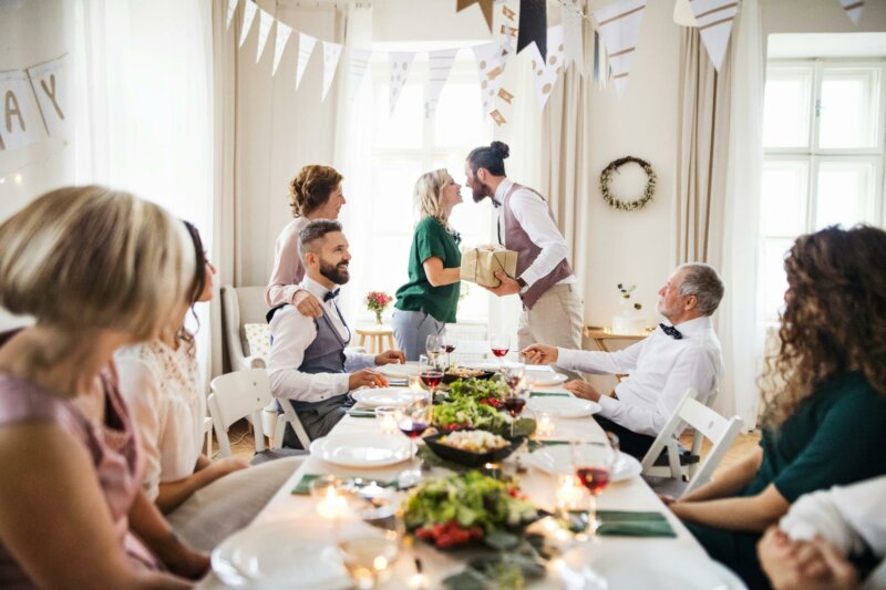 Couple kissing at a table with a gift