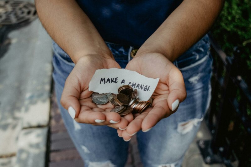 Make a change note with coins in someone's hands