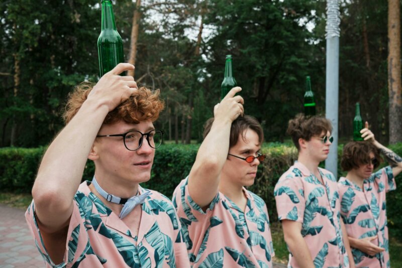 Young men with beer bottles