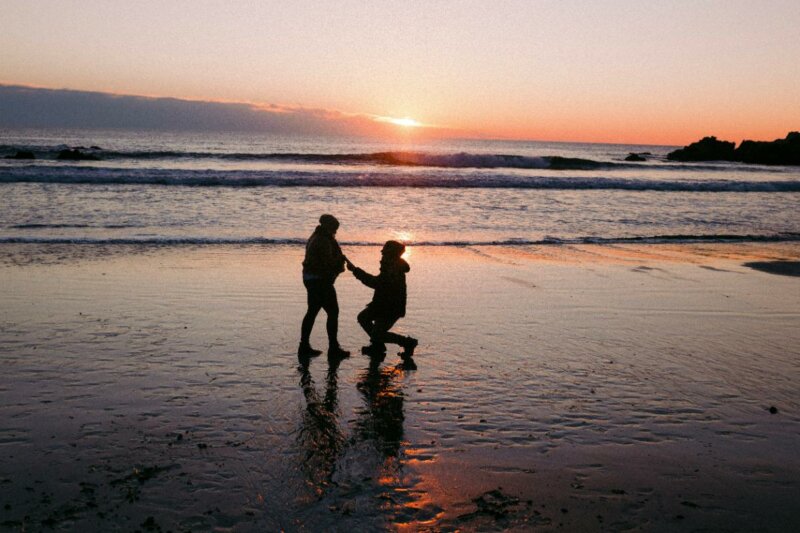 Man proposing at sunset on a beach