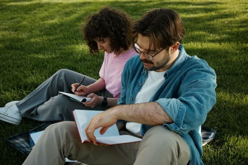 Couple writing in a park