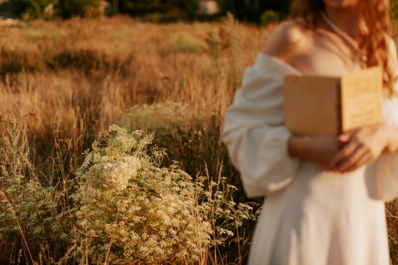 Bride reading in a field of flowers