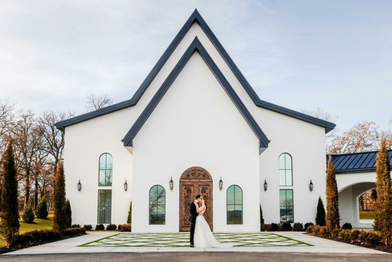 Couple posing in front of a church