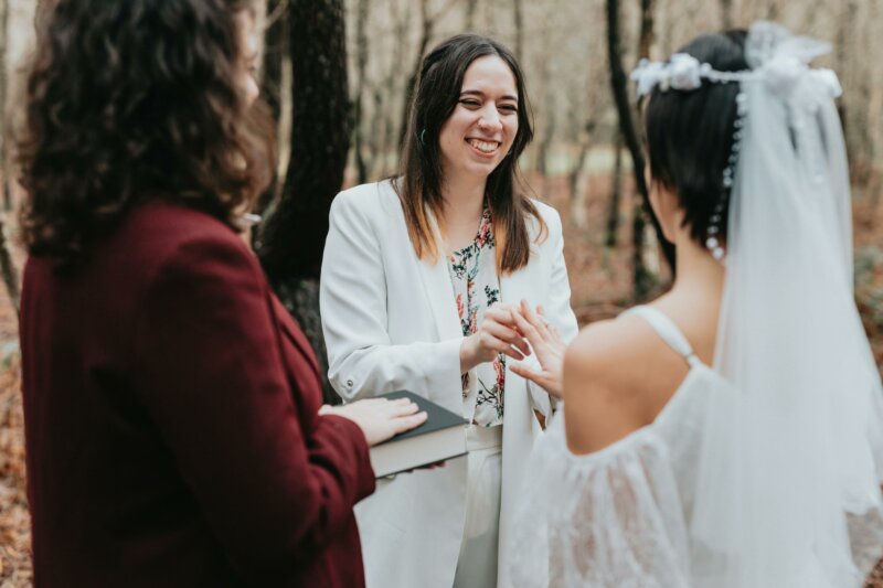 Celebrant marrying a couple in the woods