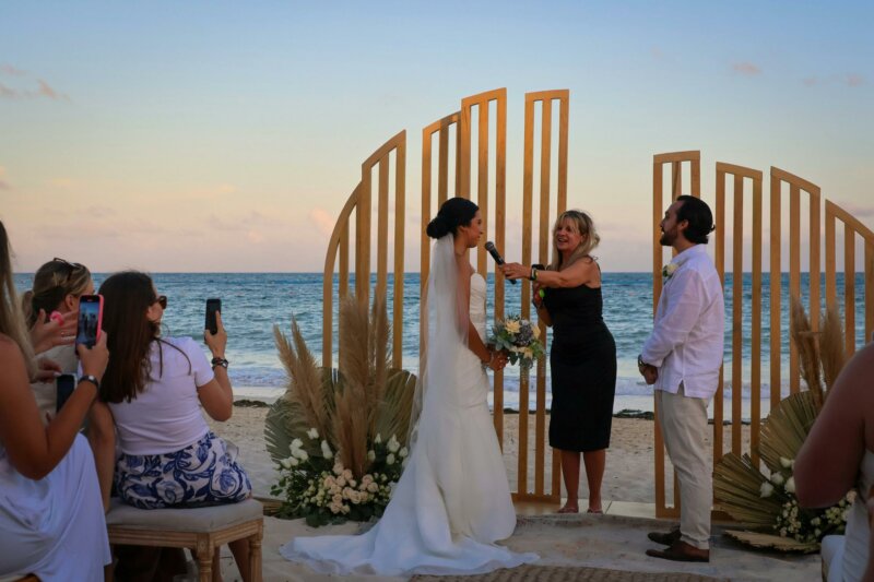 Couple getting married on a beach with a celebrant