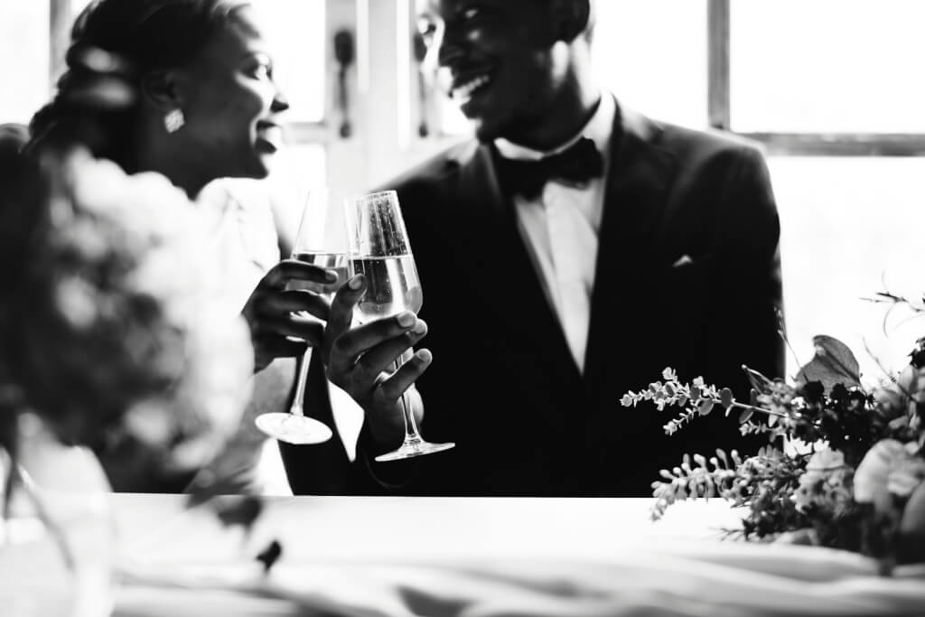 Photo in black and white of a couple toasting to their wedding