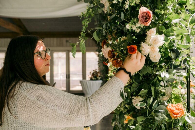 Wedding planner arranging flowers