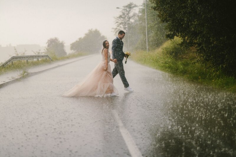 Married couple on a road under the rain