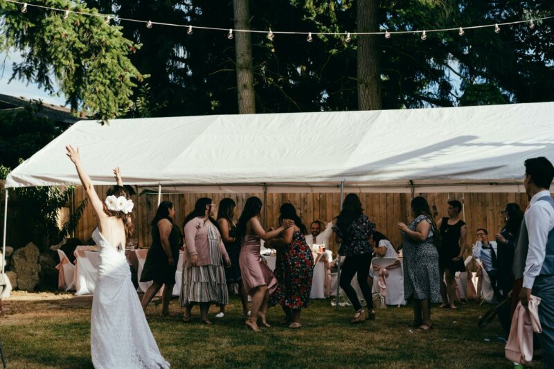 Bride and guests under a marquee