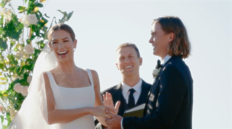 Couple getting married and laughing with a celebrant